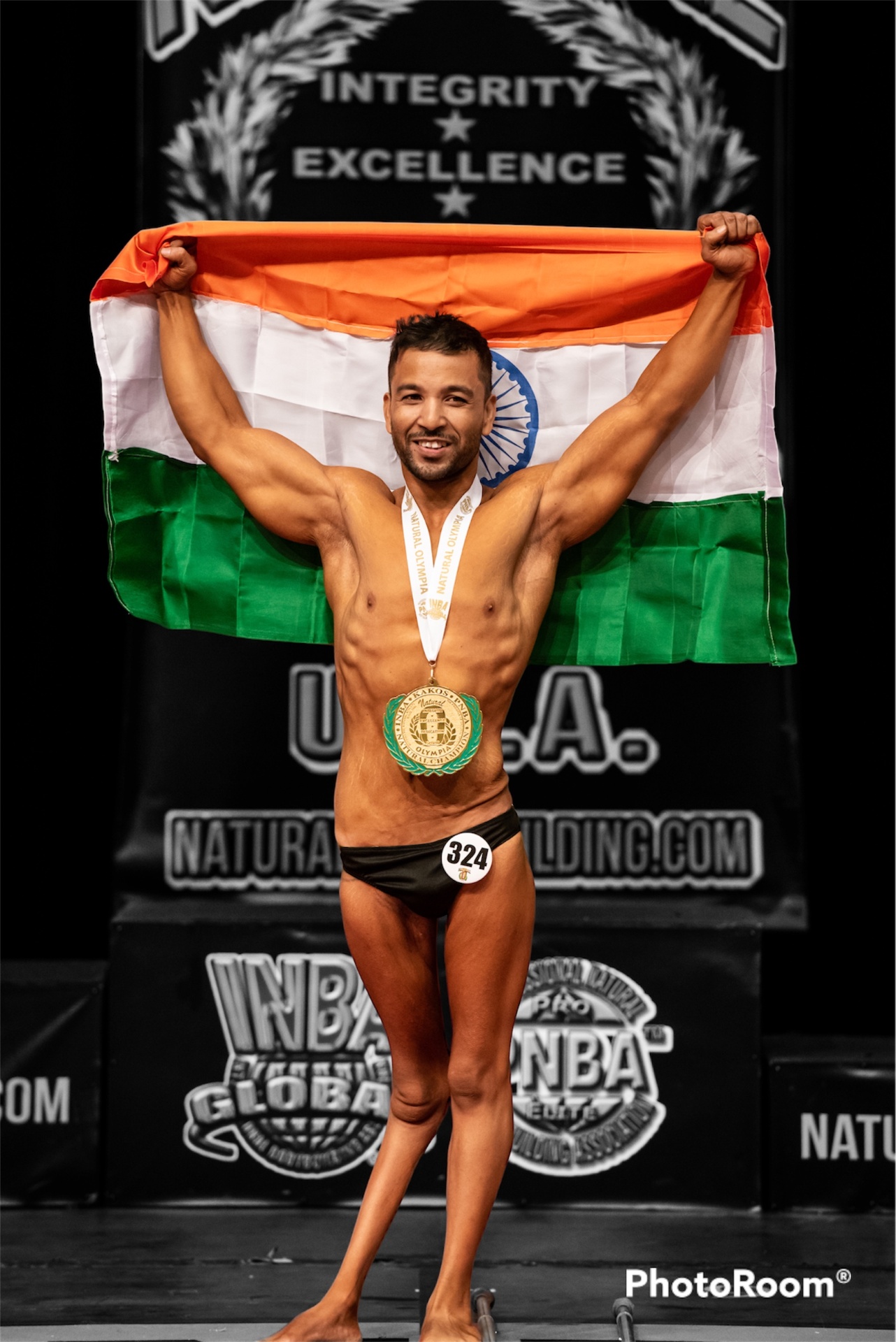 Sanjeev Kaliwala with his championship medal and Indian flag